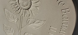 Relief carving of sunflower and lettering in Yorkstone