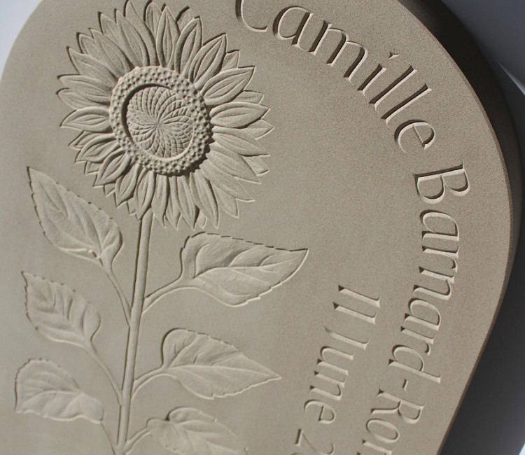 Small memorial with sunflower carving